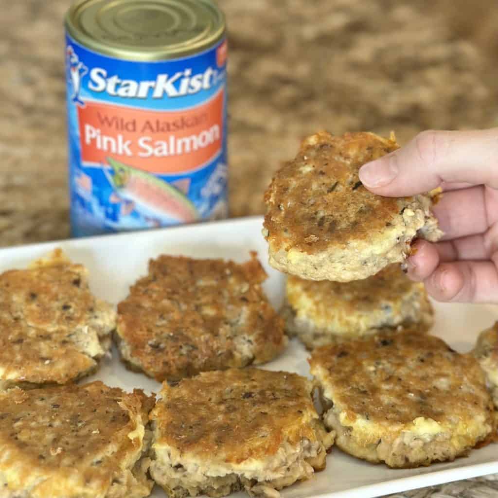 Holding a salmon patty.