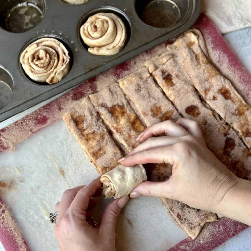 Rolling up apple cinnamon rolls