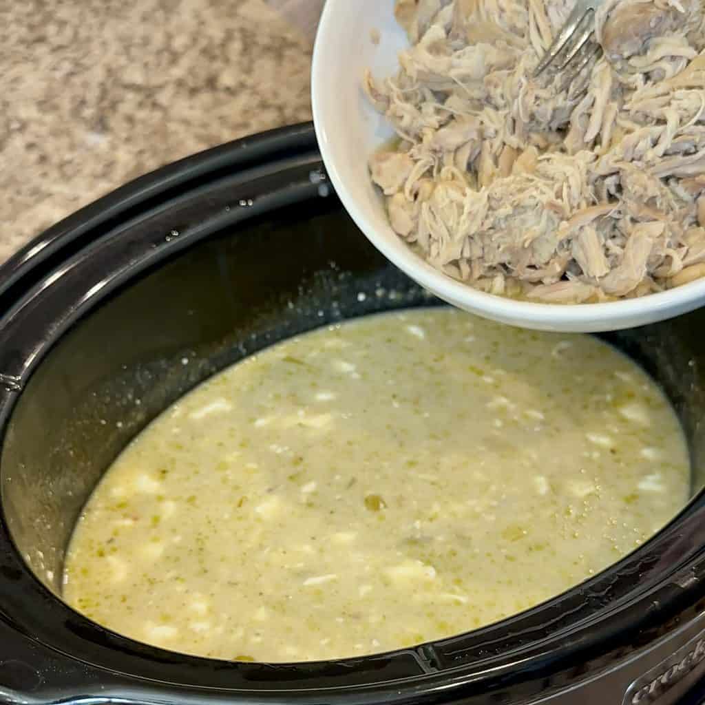 adding chicken to the crockpot