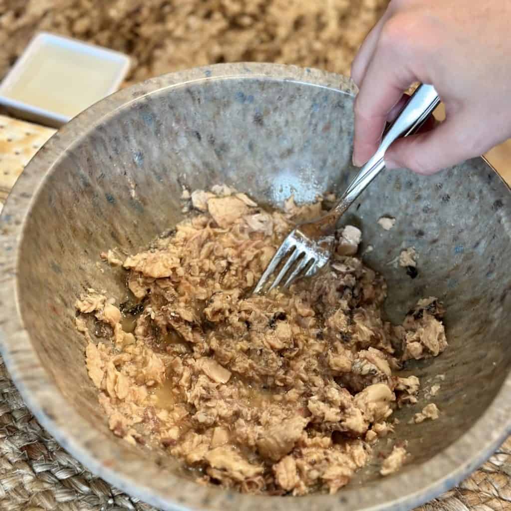 Mixing together ingredients for salmon patties.