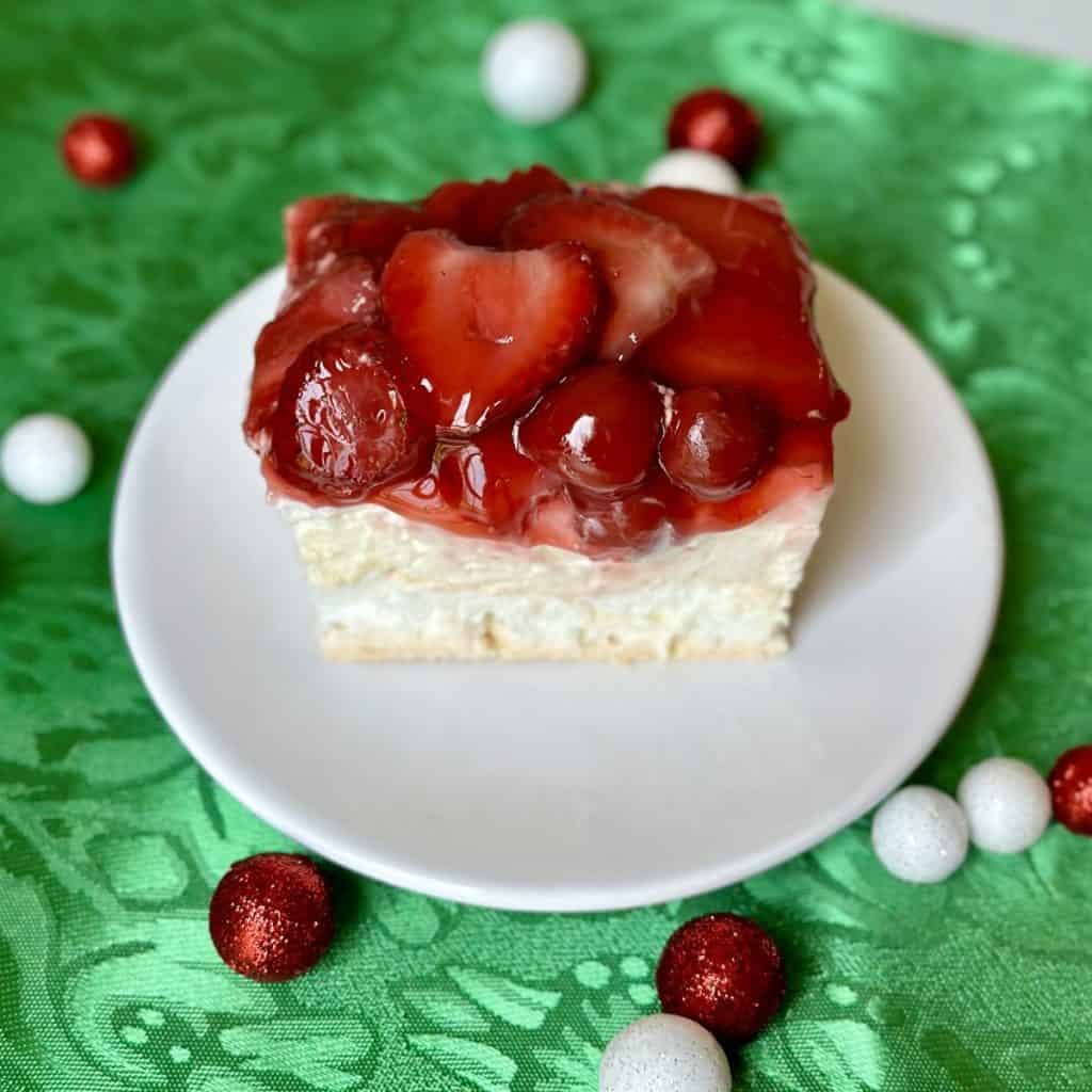 A slice of cherry berry on a cloud on a plate.