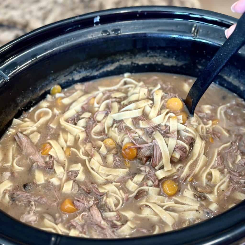 A finished beef and noodle meal in the crockpot.