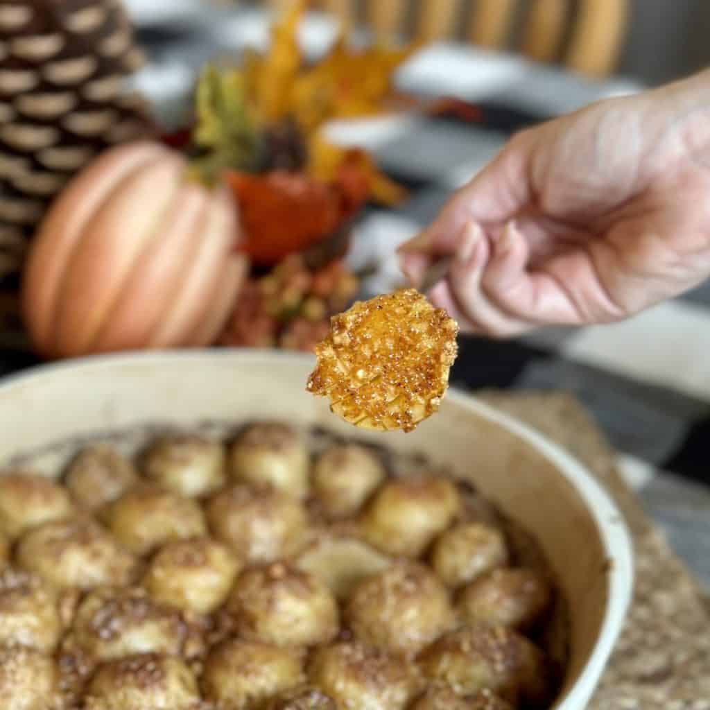 A bite of a potato on a fork.