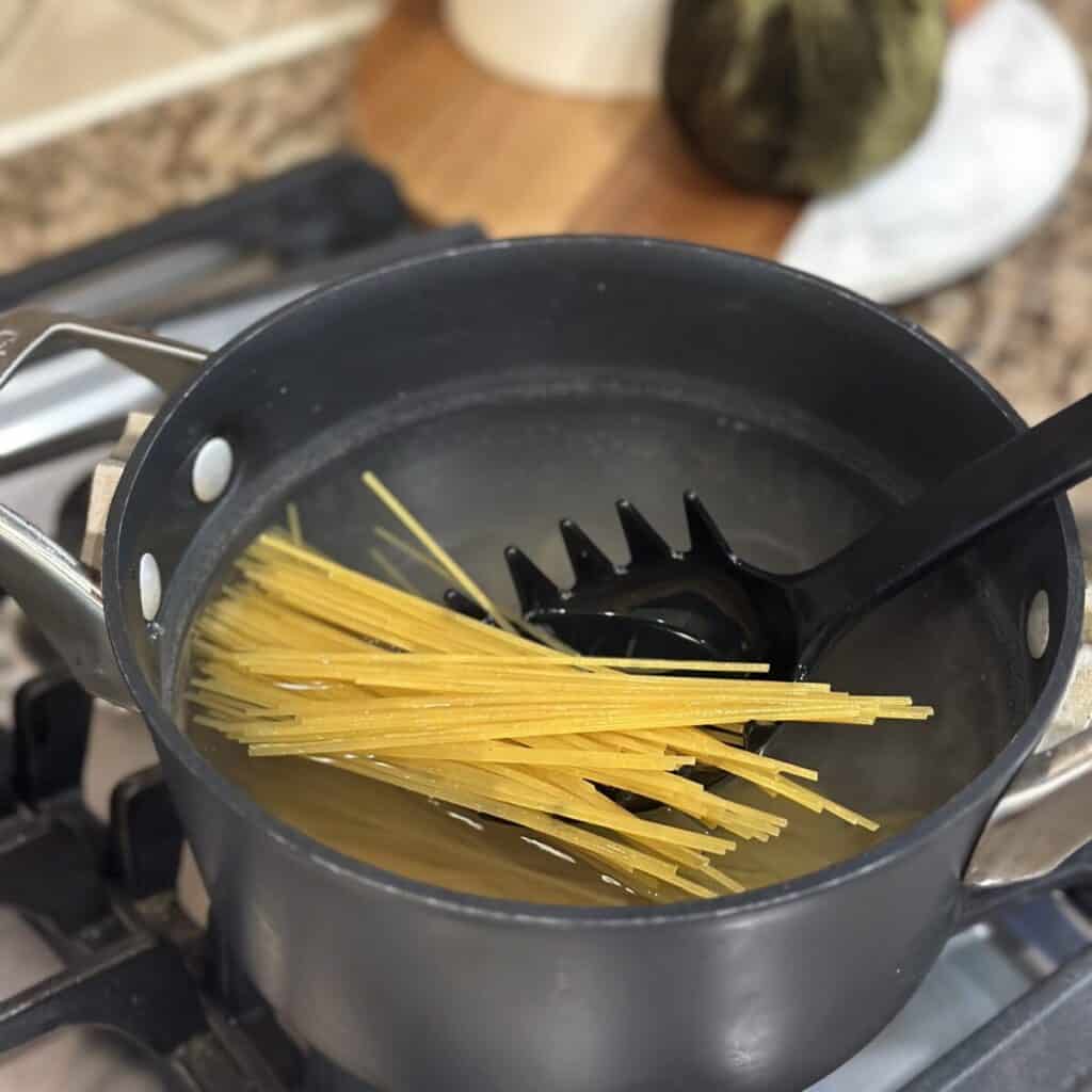 Boiling spaghetti in water.