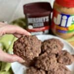 Holding a chocolate peanut butter no bake cookie.