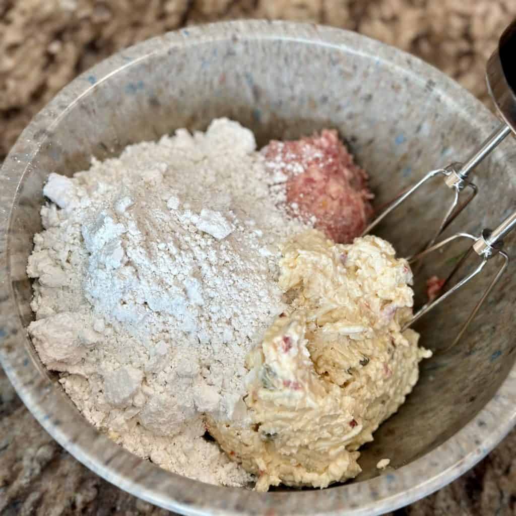 Ingredients in a bowl to make sausage balls.