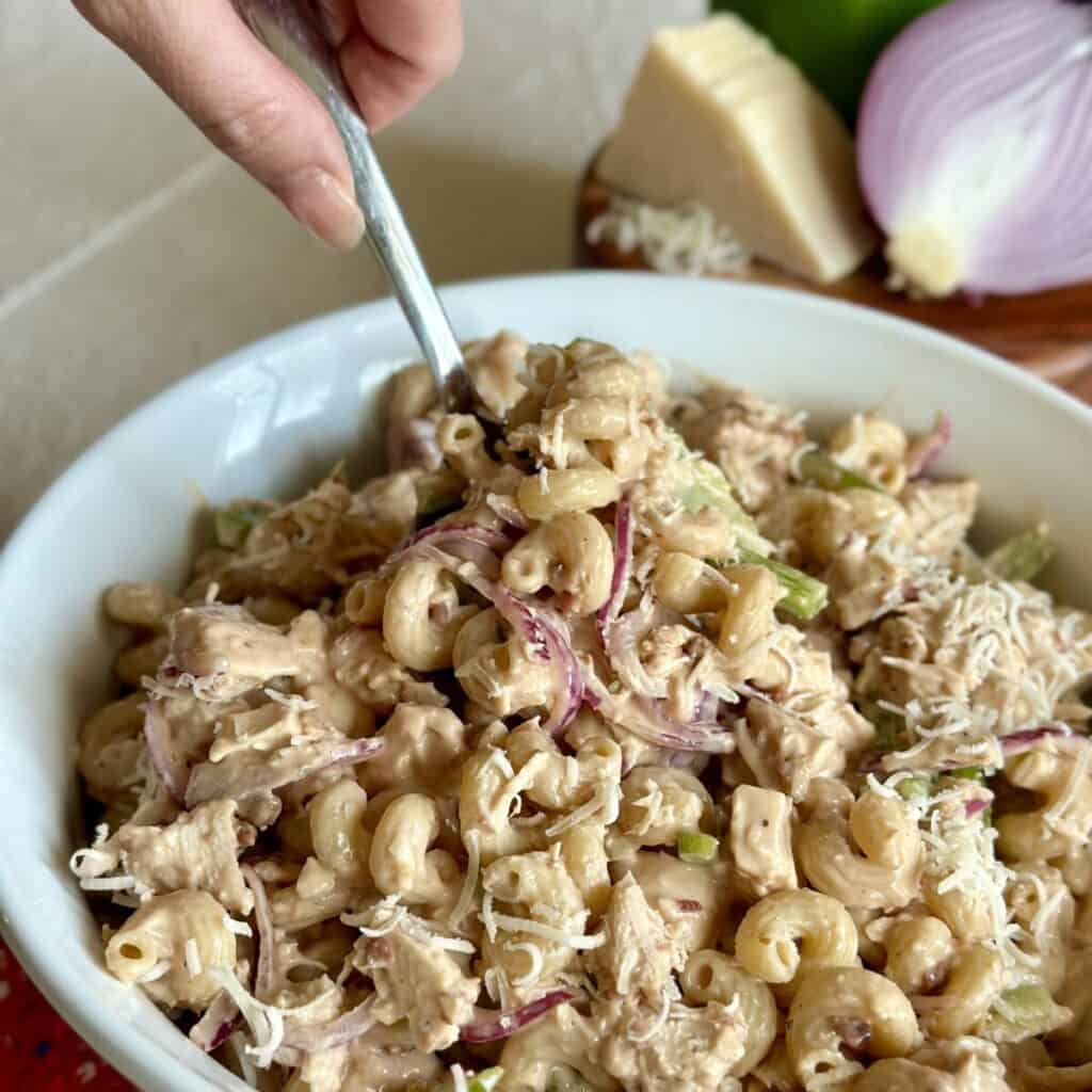 Getting a spoonful of pasta salad.