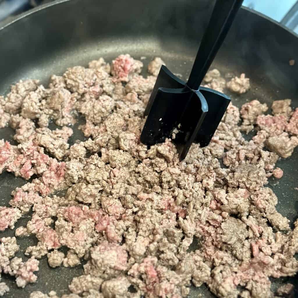 Cooking ground beef in a skillet.