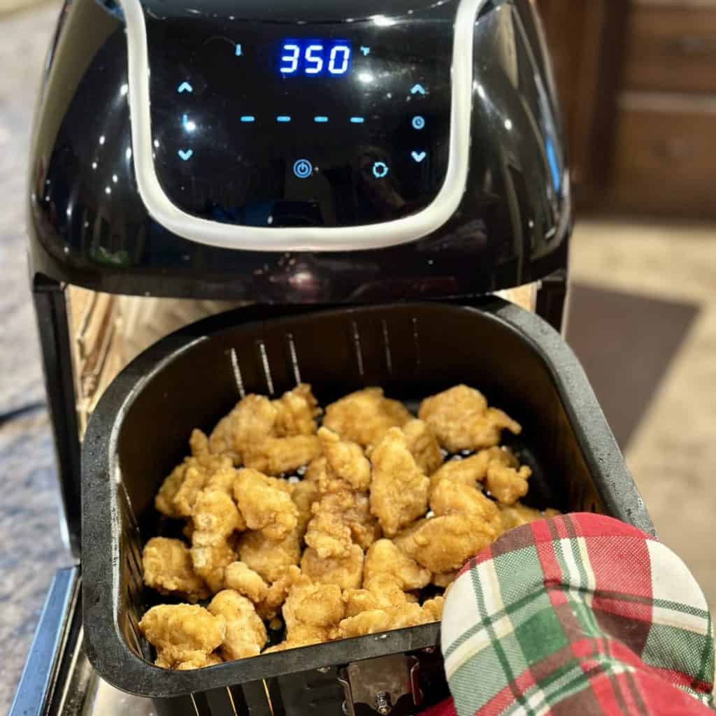 Air frying chicken for chicken sandwiches.