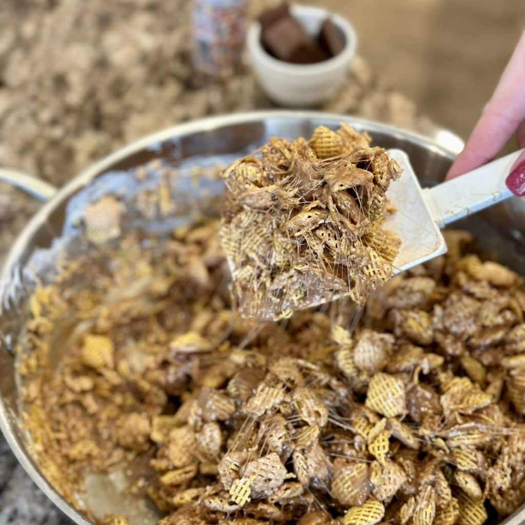 Crispix, peanut butter, hazelnut spread, marshmallows and butter in a pan.