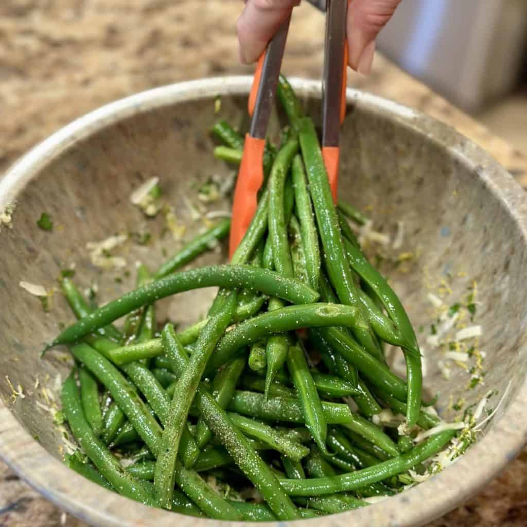 Tossing green beans with gremolata.