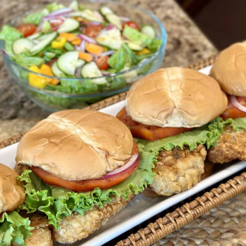 A plate of fried pork tenderloin sandwiches.