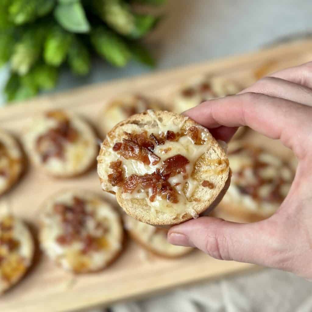 A close up shot of a cheesy bacon appetizer.