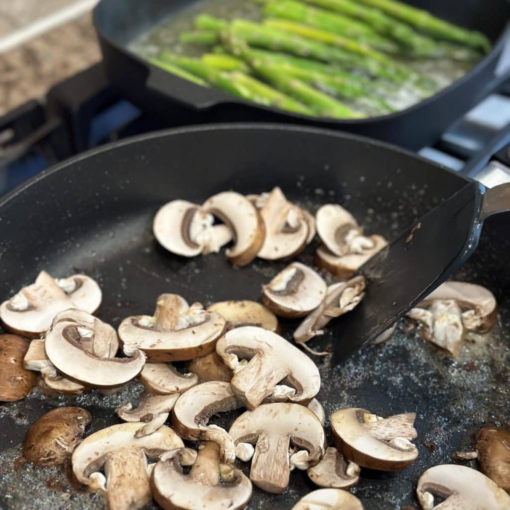 Sautéing mushrooms in a pan.