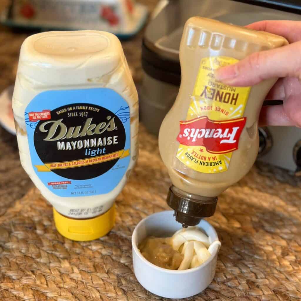 Mixing a spread for a panini sandwich with mayo and honey mustard.