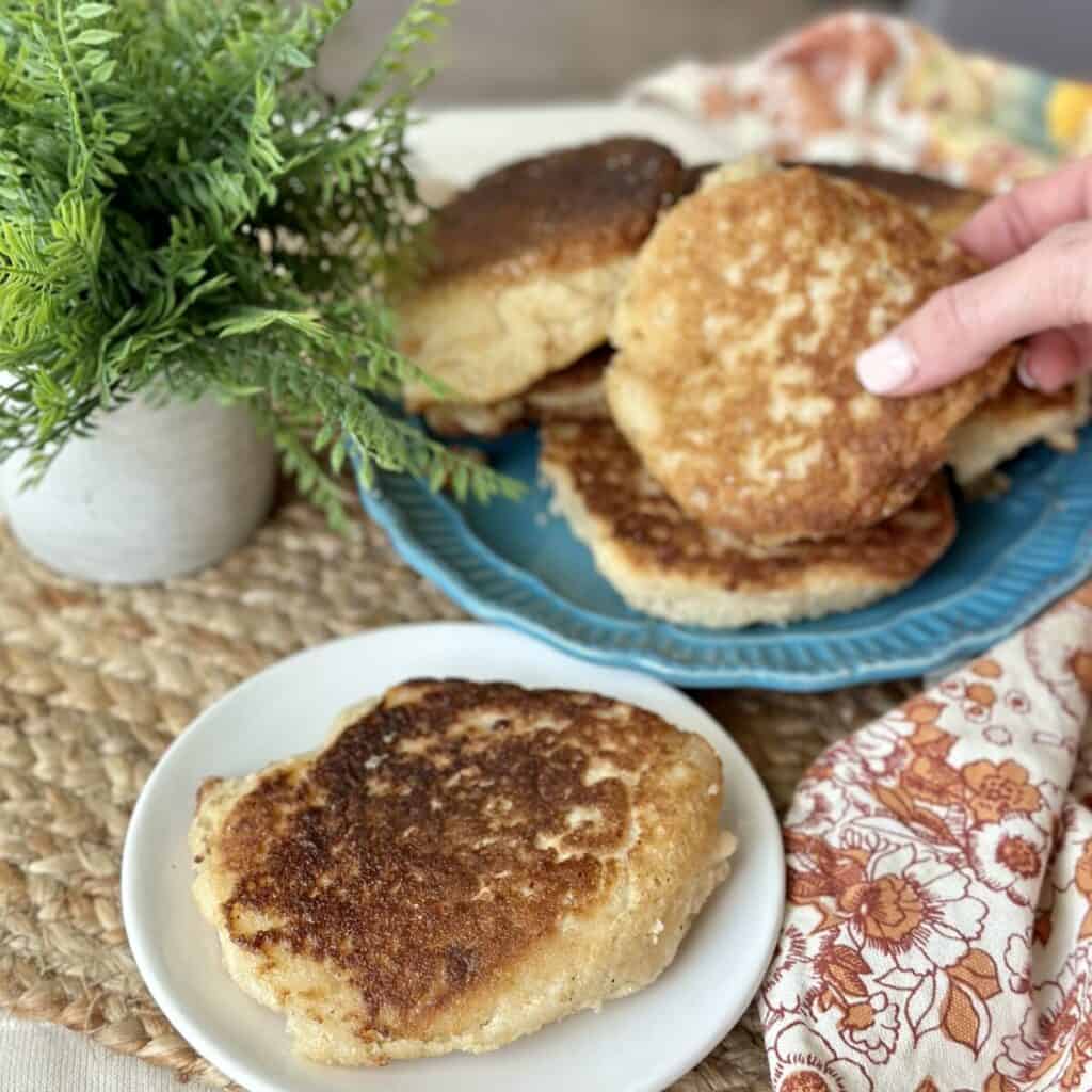 Grabbing a hoecake from a stack of hoecakes.