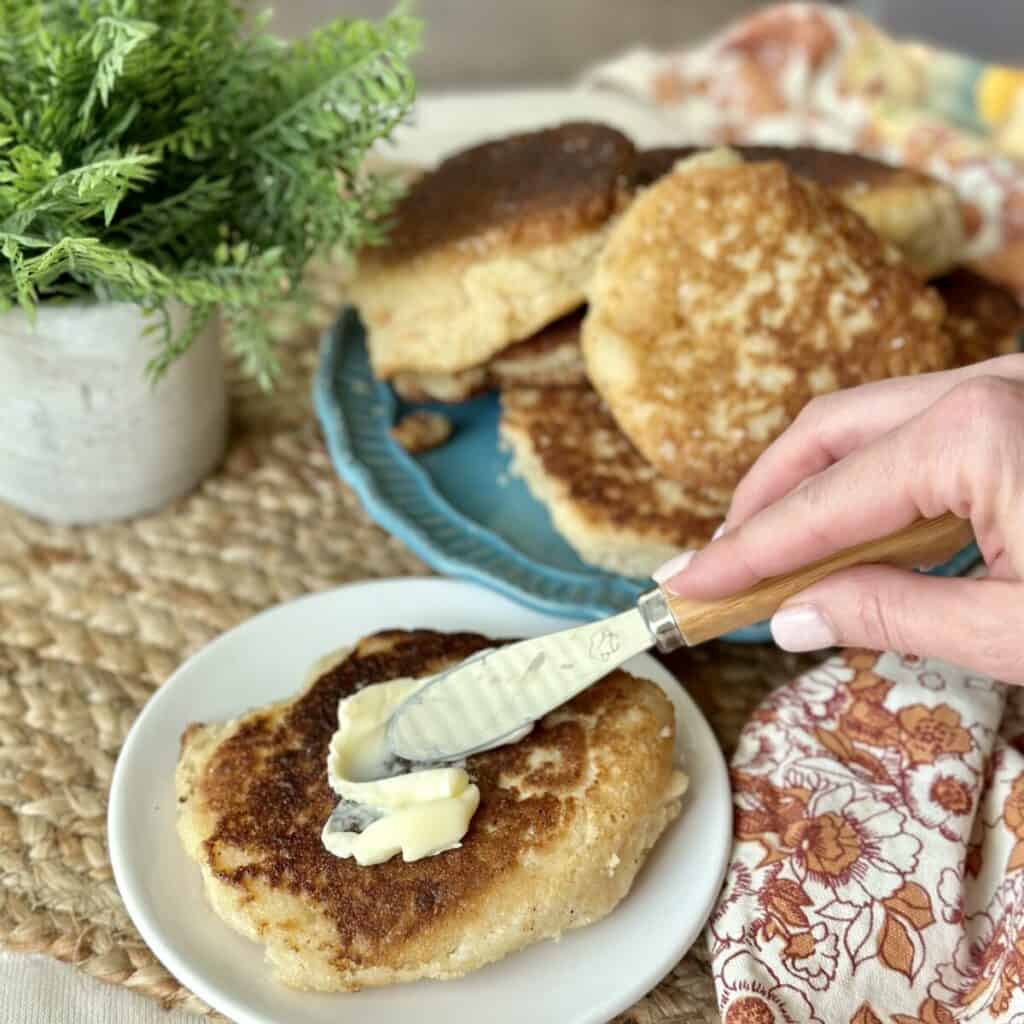 Spreading butter on a hoecake.