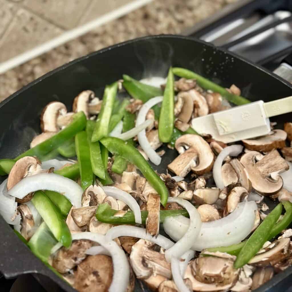 Cooking vegetables in a skillet.