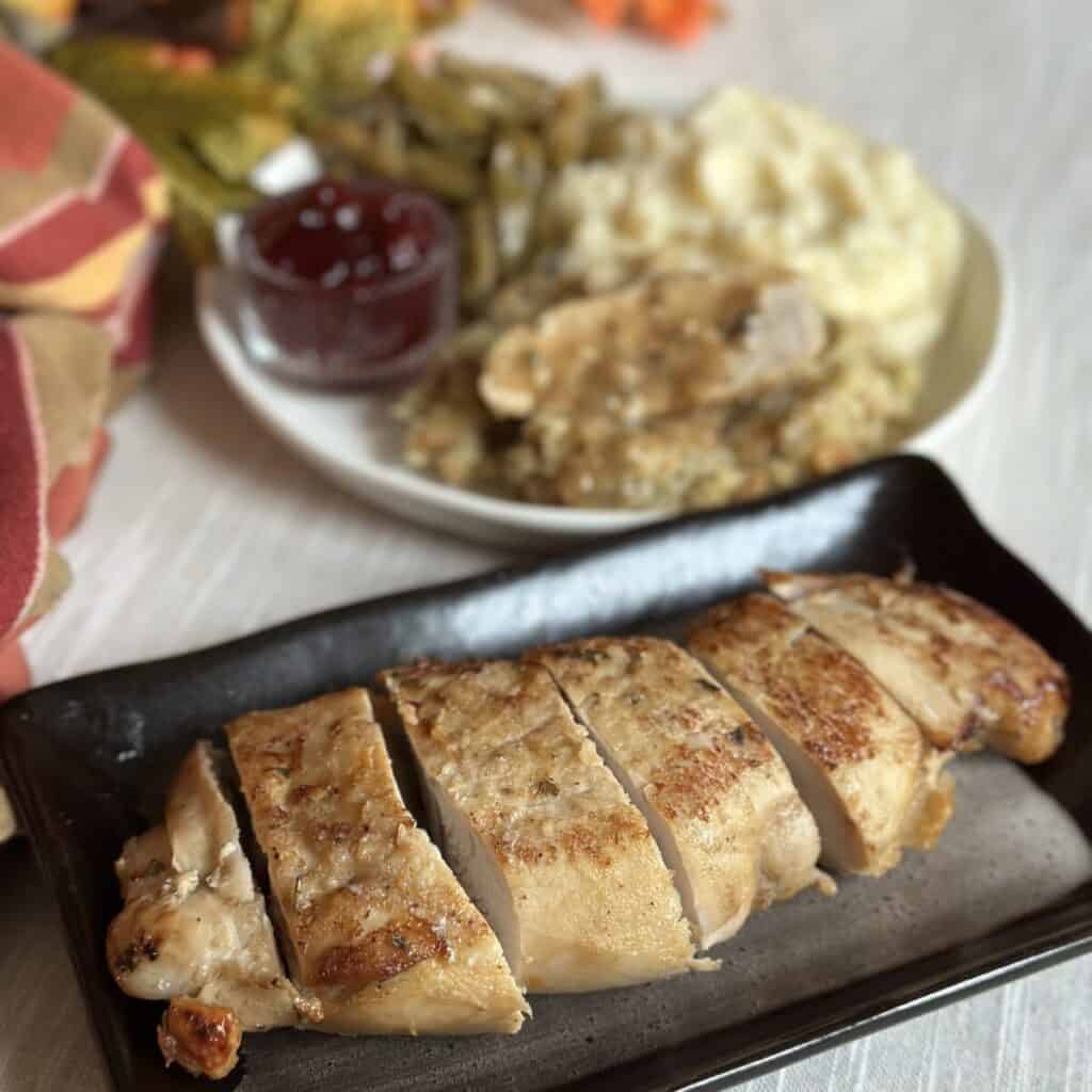 Cooked turkey tenderloins on a plate.