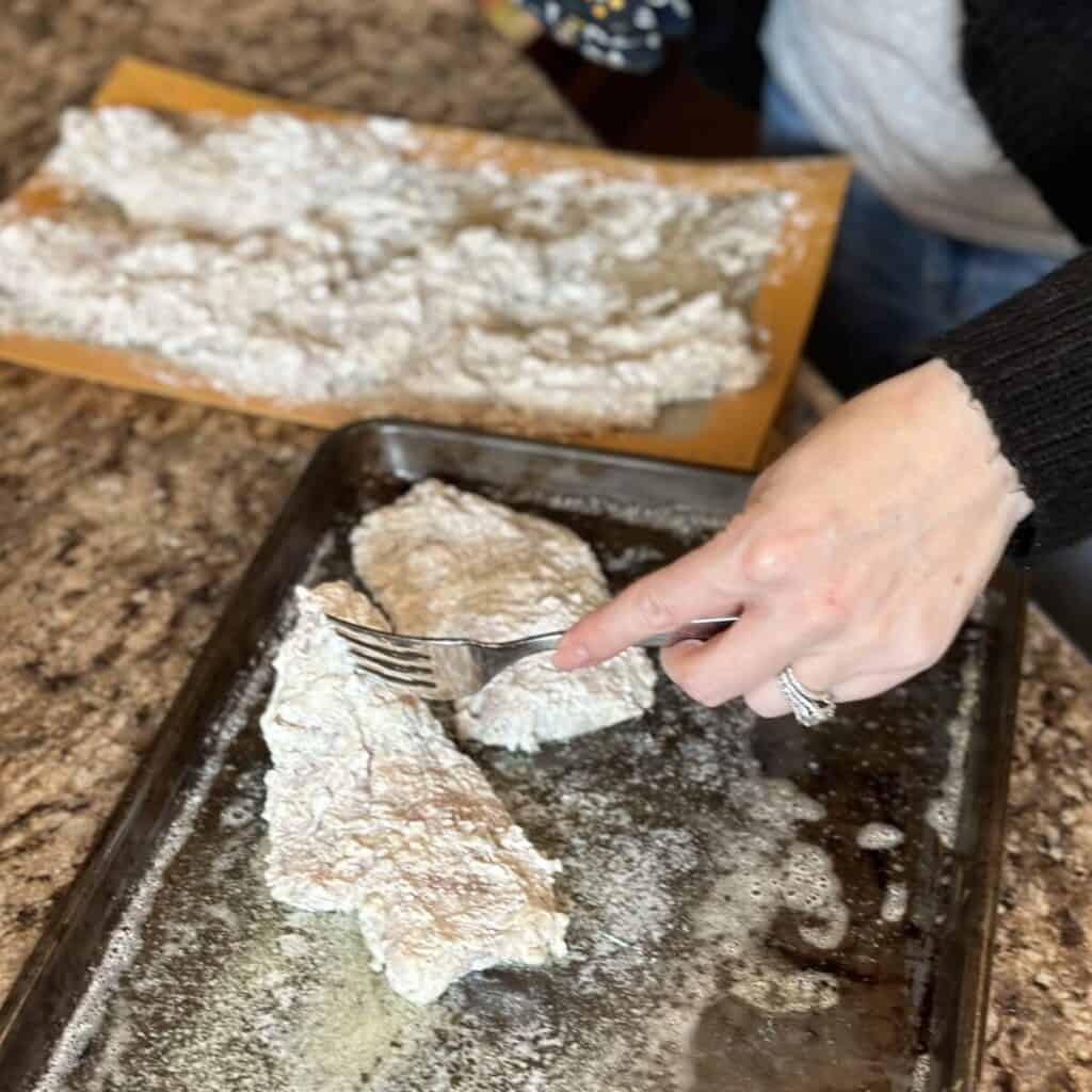 Laying chicken on a sheet pan.