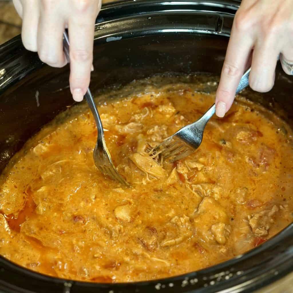 Shredding chicken in a crockpot.