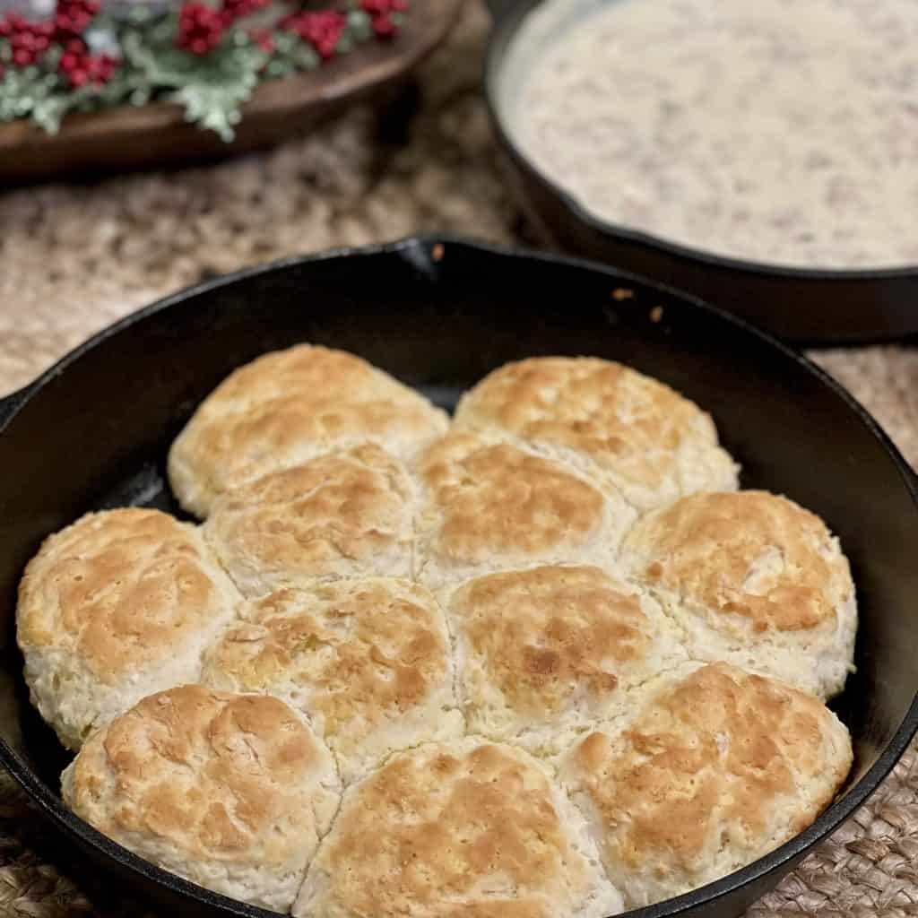 This is a picture of a cast iron skillet of biscuits and sausage gravy.