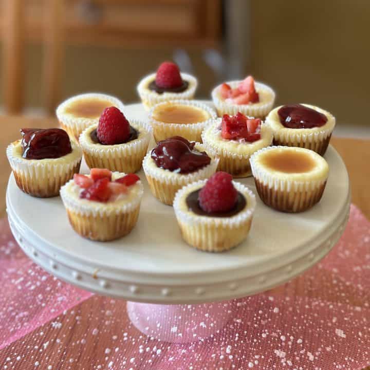 This is a picture of a plate of mini cheesecakes.