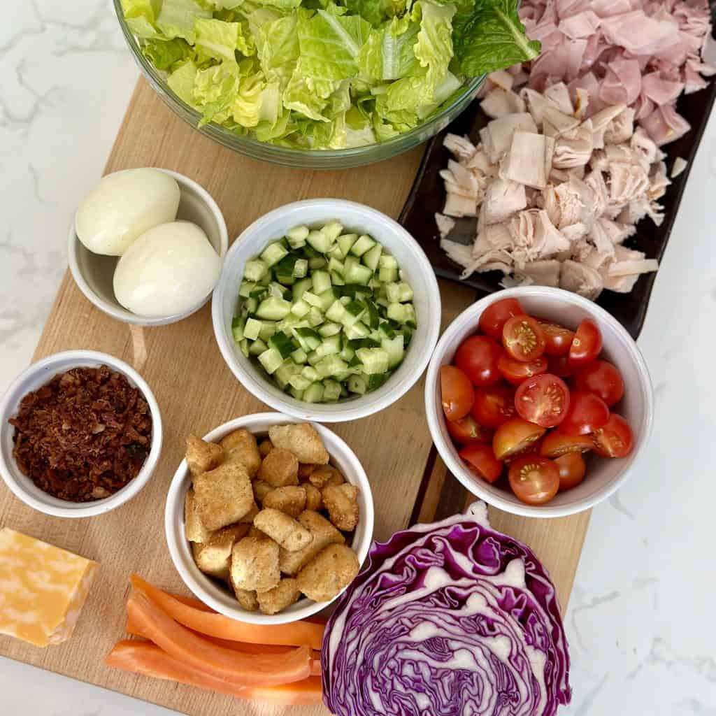 all ingredients displayed on a cutting board in individual cups