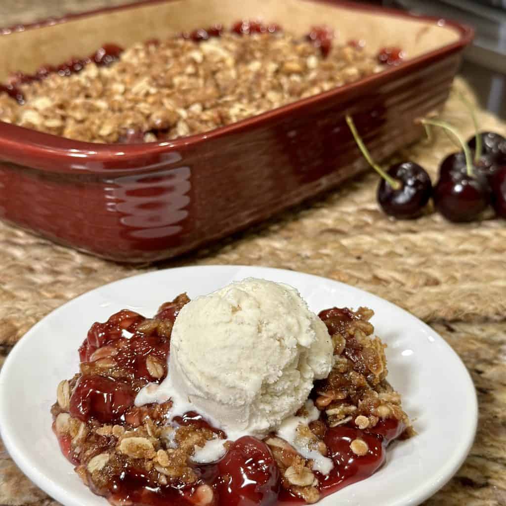 cherry crisp served with a scoop of ice cream