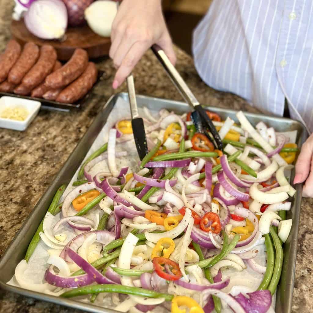 tossing vegetables in olive oil, vinegar and seasonings