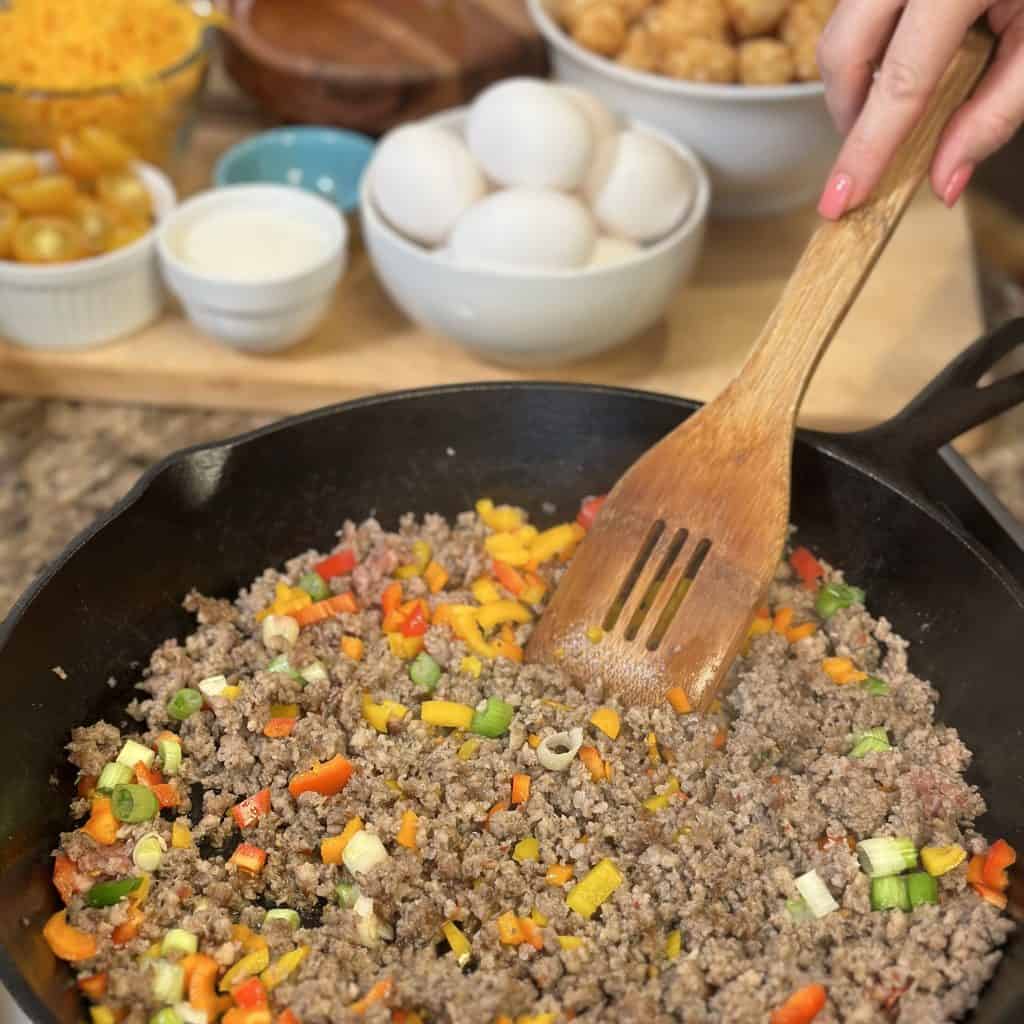 sautéing the peppers and onions with the sausage