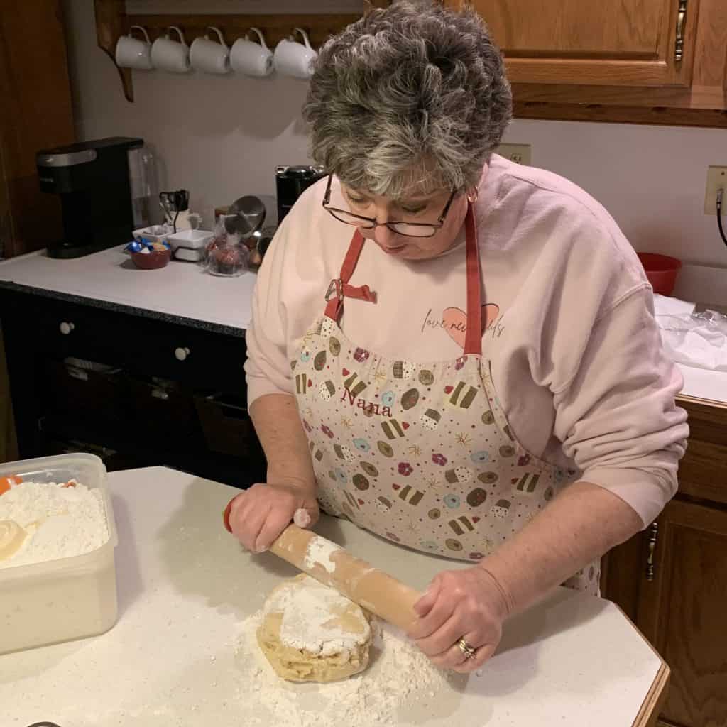 rolling out the cookie dough on a floured surface