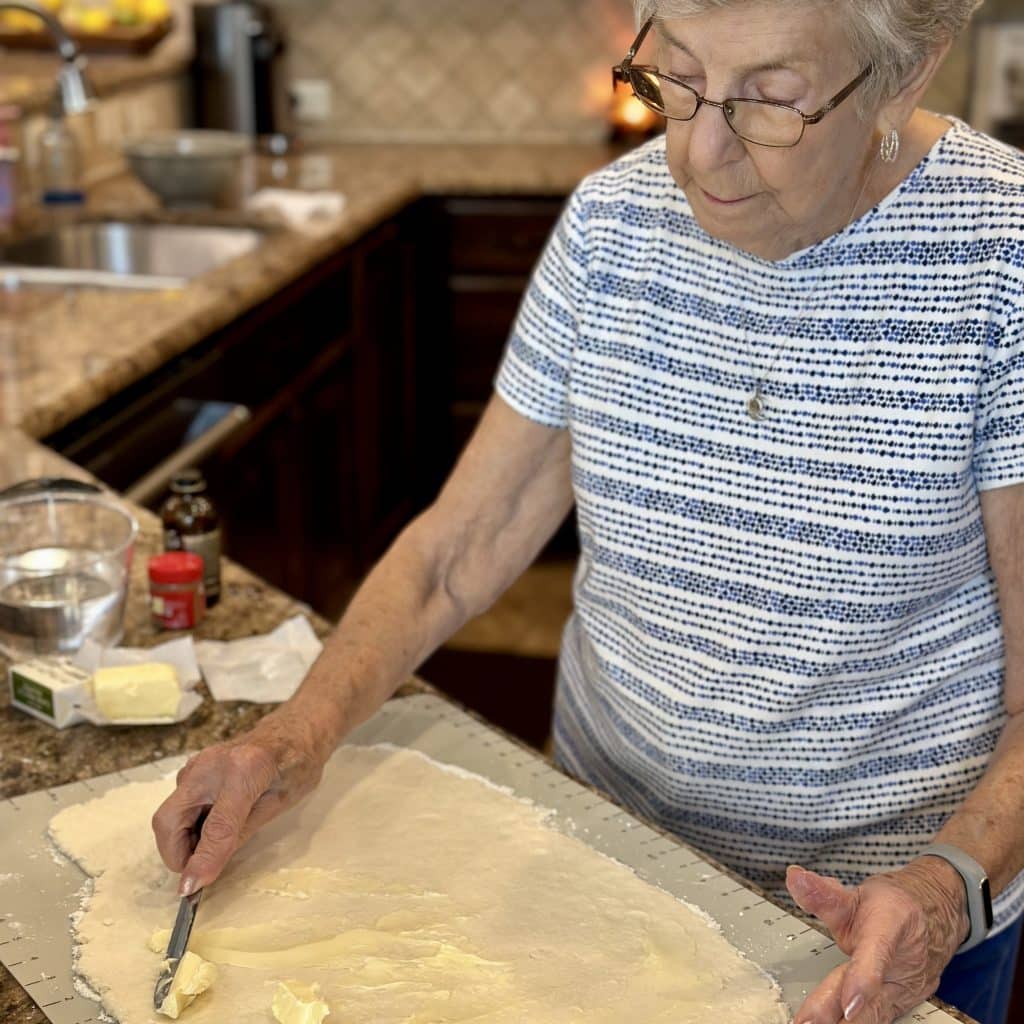 spreading butter on the dough