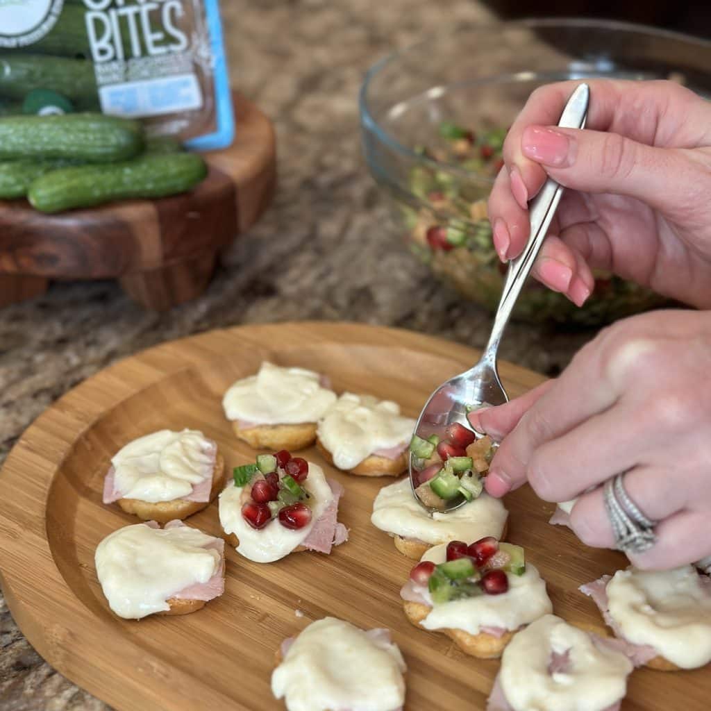 adding topping mixture to crackers