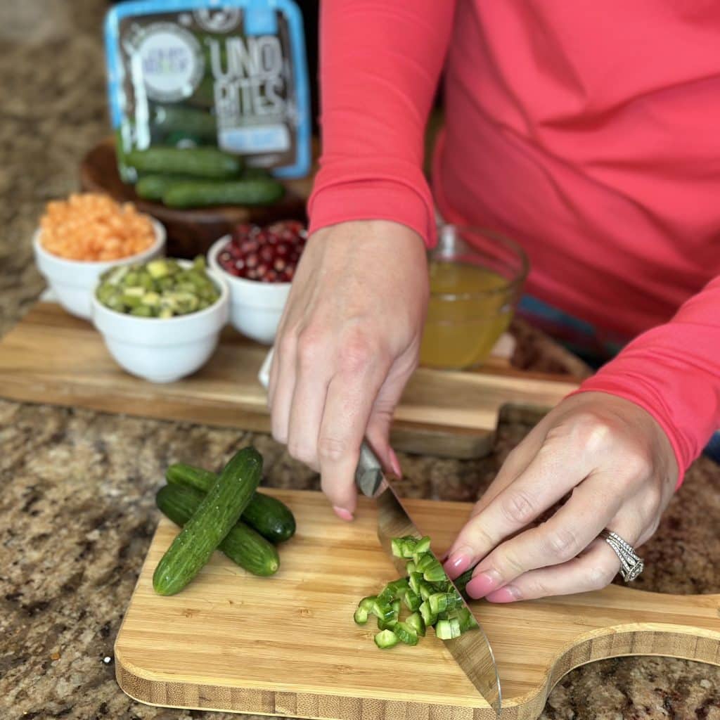 chopping cucumbers on cutting board