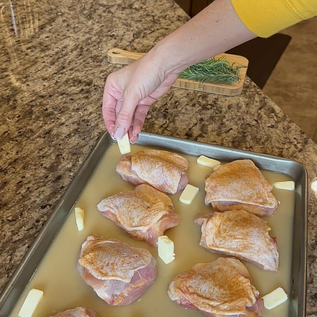 distributing cold butter cubes around the chicken