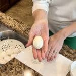 An egg that’s been peeled away from it’s shell and laying in a hand