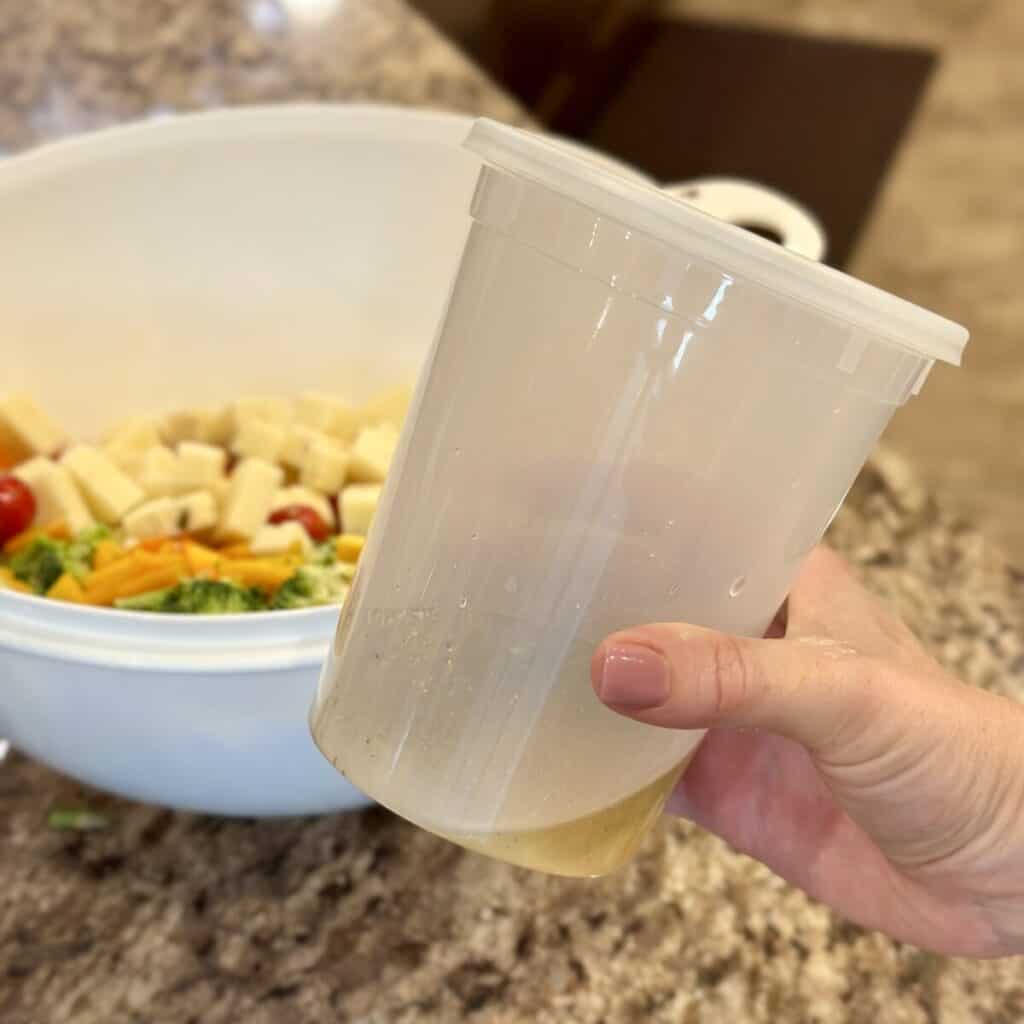 Mixing up a dressing in a cup.