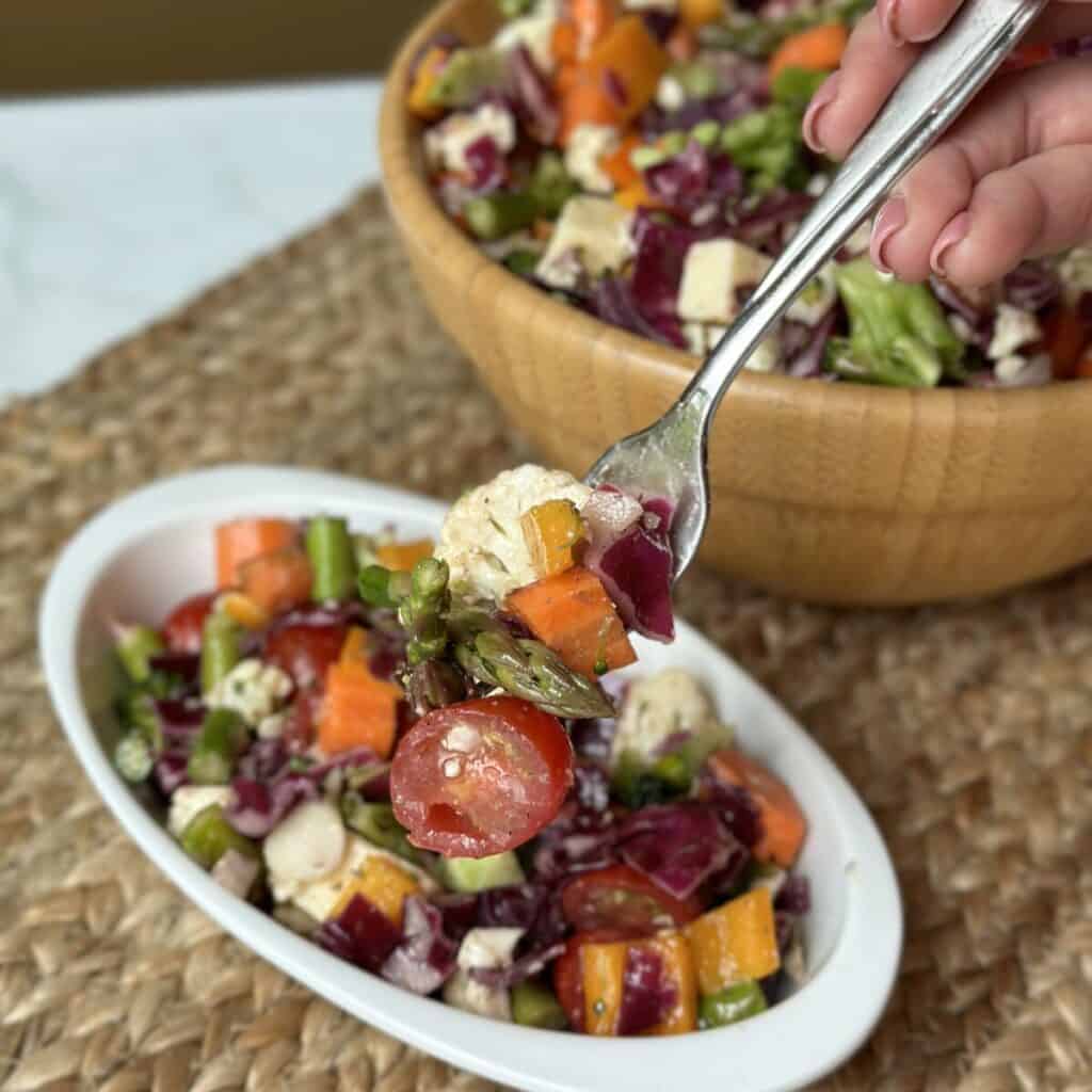 A forkful of marinated vegetable salad.