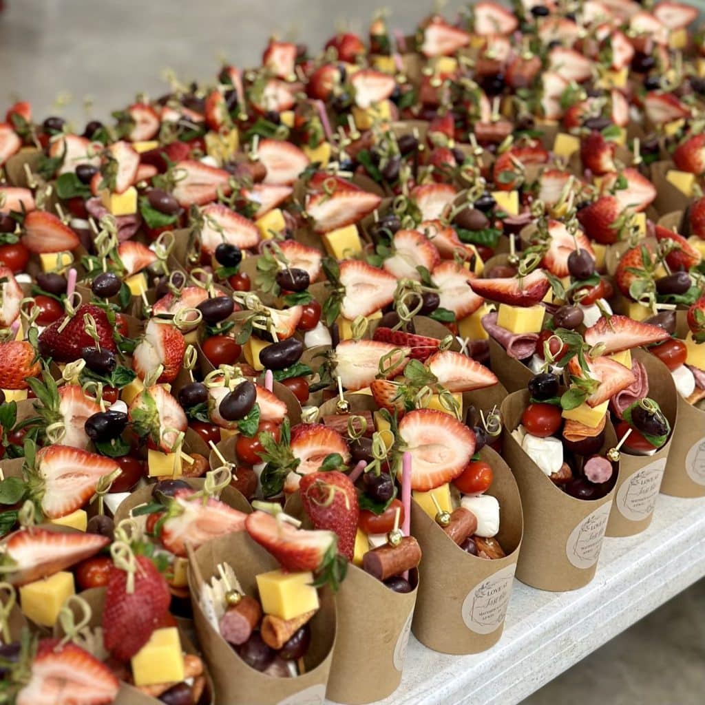 a tray filled with completed charcuterie cups