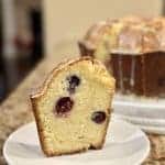 A slice of lemon blueberry pound cake on a saucer