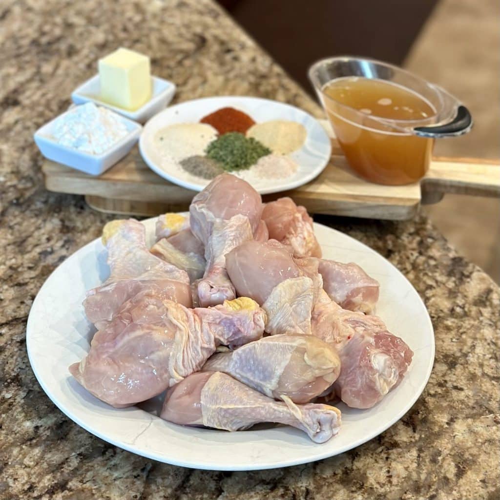 The ingredients to make roasted juicy drumsticks: chicken, broth, flour, butter and seasonings.