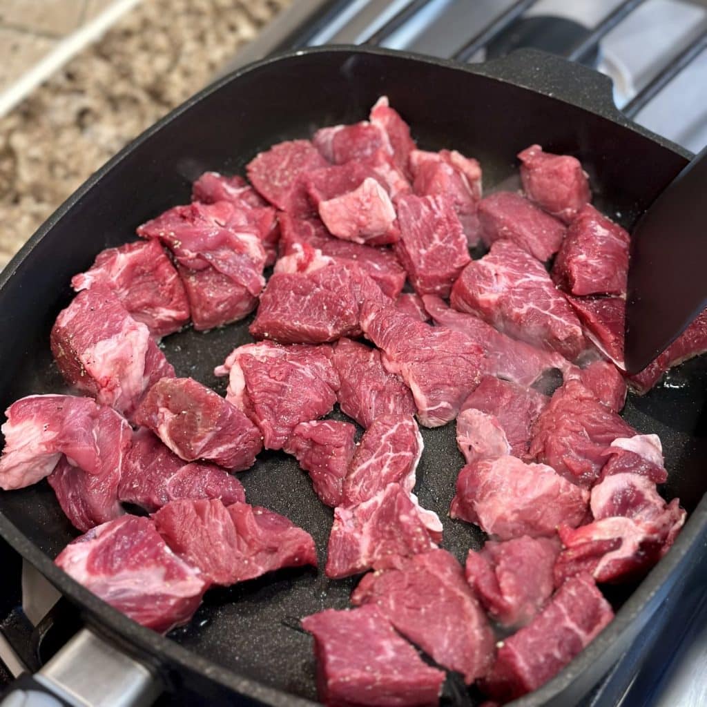 Searing a chuck roast in a skilet.