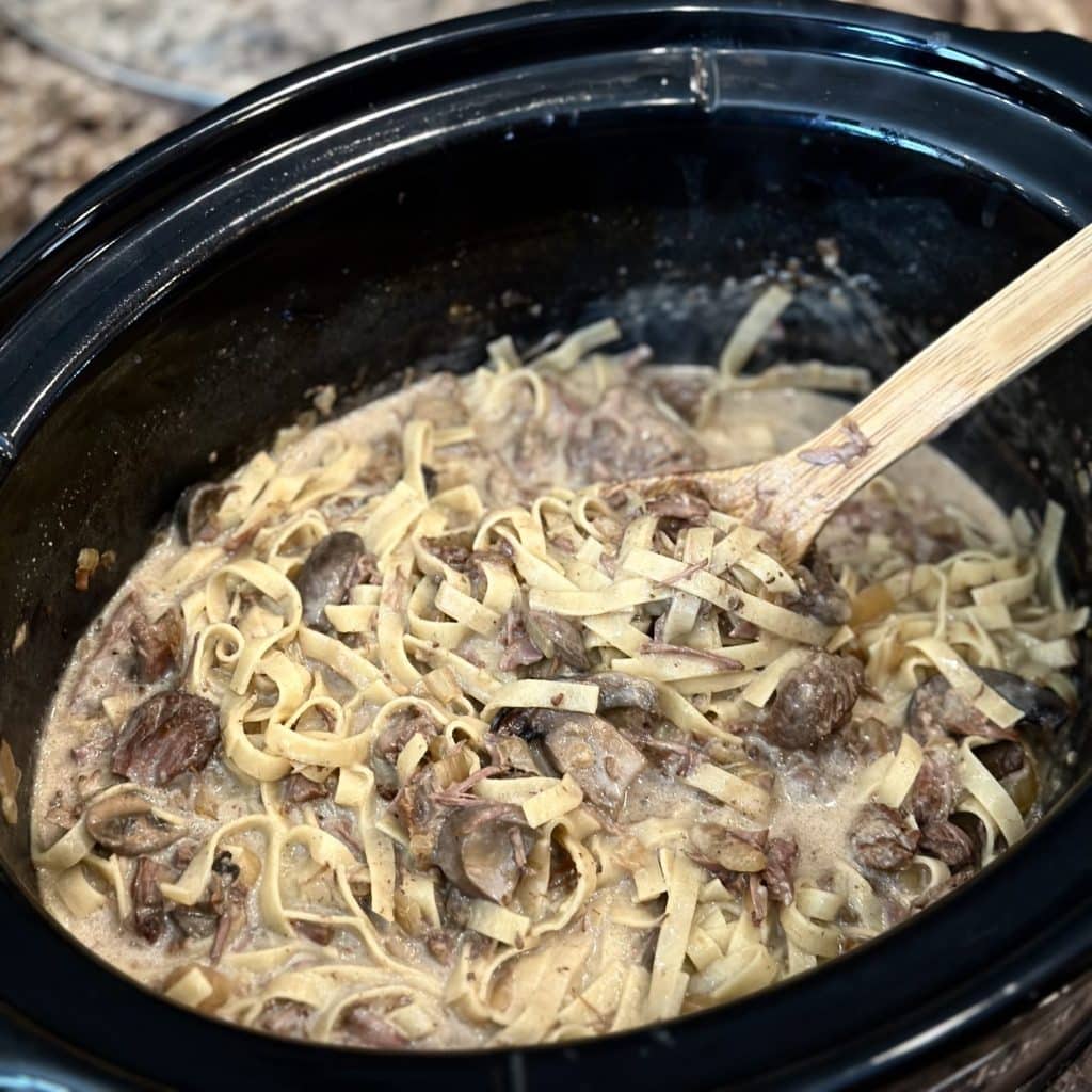 A crockpot of beef stroganoff.