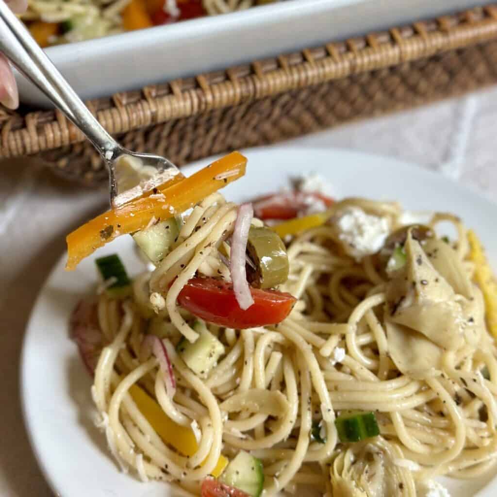 A forkful of cold spaghetti salad.