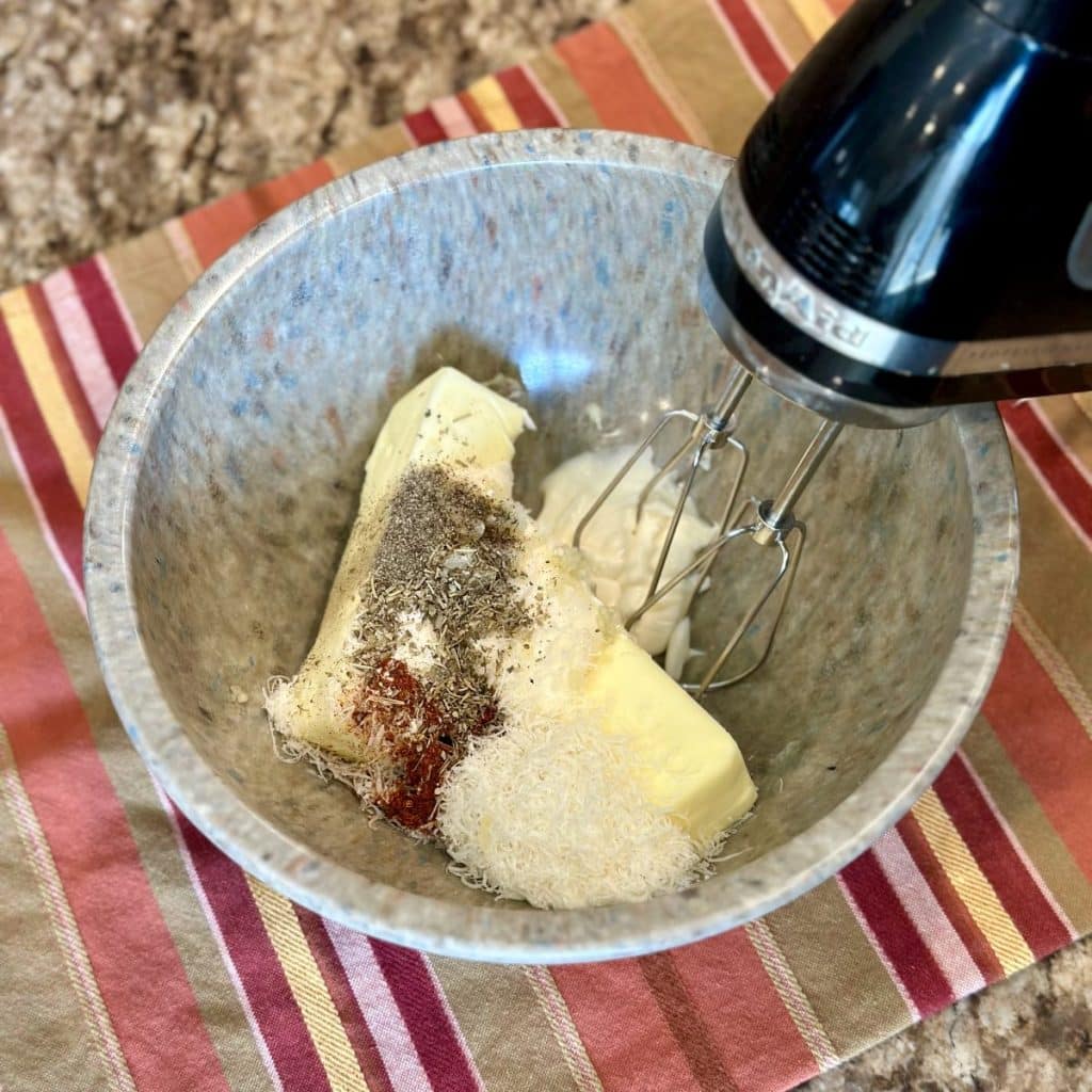 Garlic butter ingredients about to be mixed in a bowl.