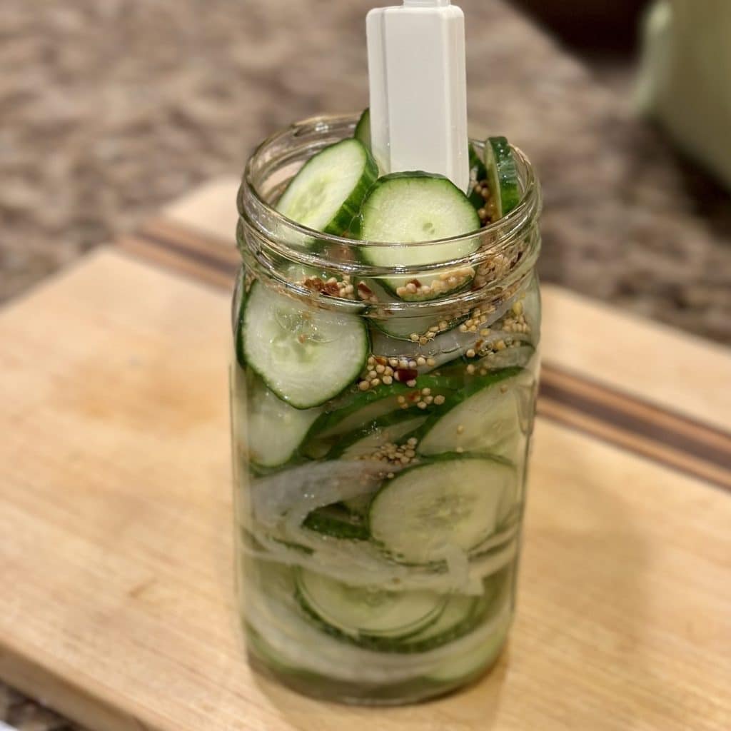 Homemade overnight pickles in a jar.