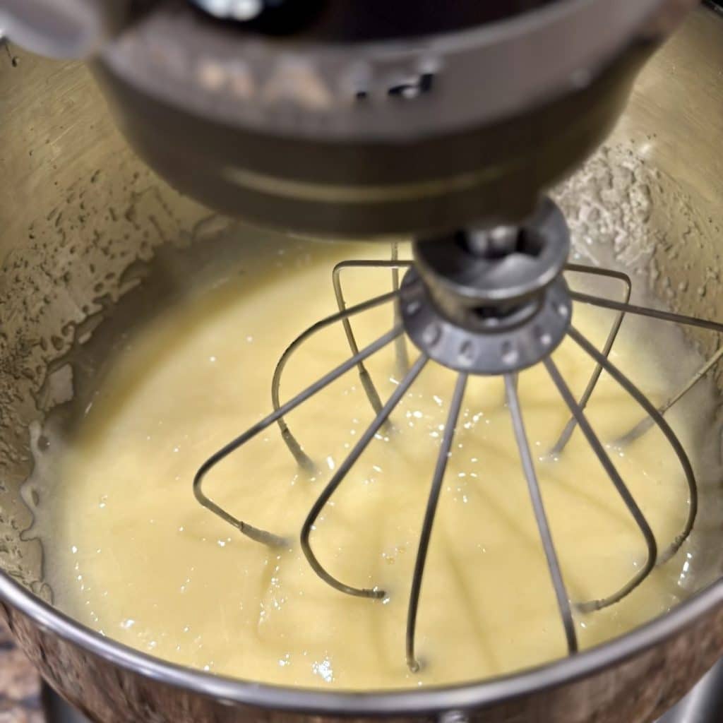 Whipping together wet ingredients for a cake in the mixer.