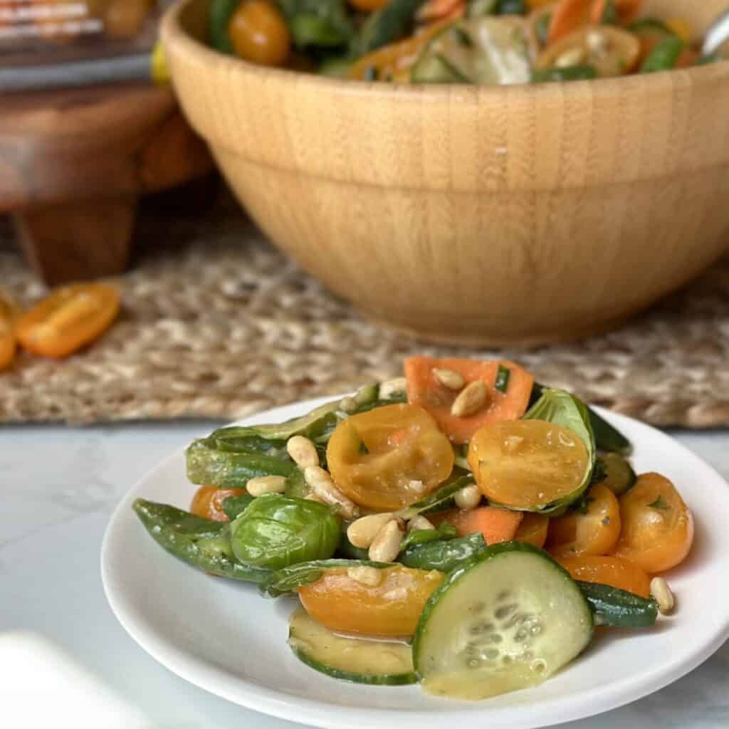 A plate of green bean and tomato salad.