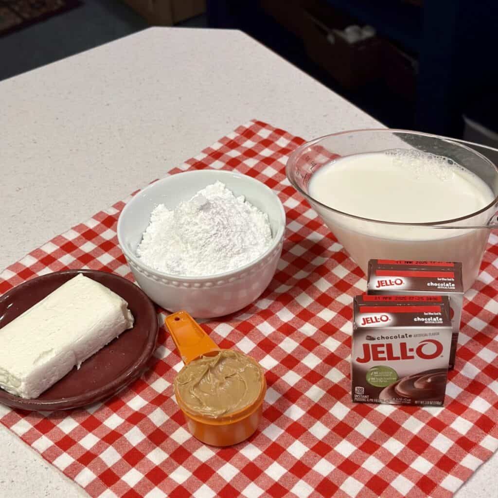 The ingredients displayed to make a chocolate peanut butter dessert.